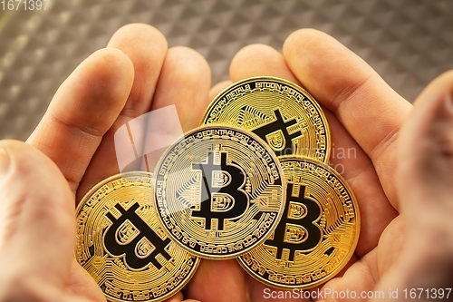 Image of Physical bitcoin held in hands closeup