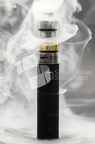 Image of Electronic cigarette against background full of smoke