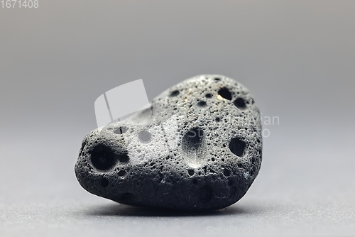 Image of Smoke whirling around small meteorite stone