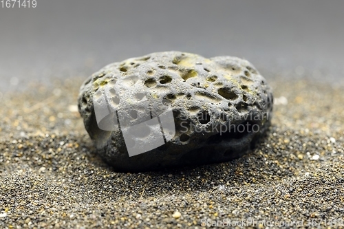 Image of Smoke whirling around small meteorite stone