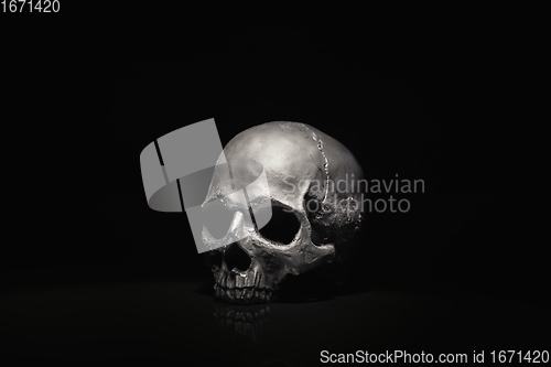 Image of Spooky dark black skull aginast dark background