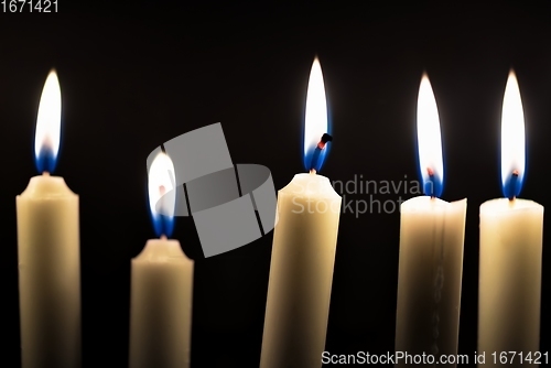 Image of Candles glowing against dark background