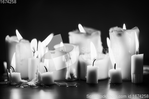 Image of Candles glowing against dark background