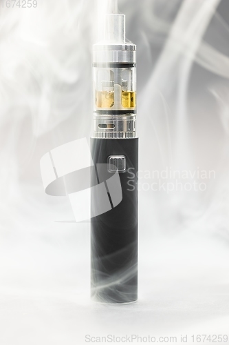 Image of Electronic cigarette against background full of smoke