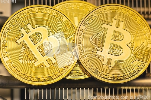 Image of Physical shiny bitcoin agains dark background