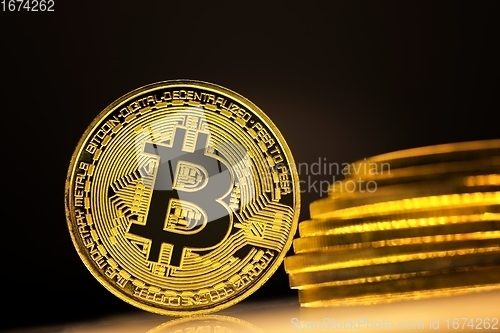 Image of Physical shiny bitcoin agains dark background