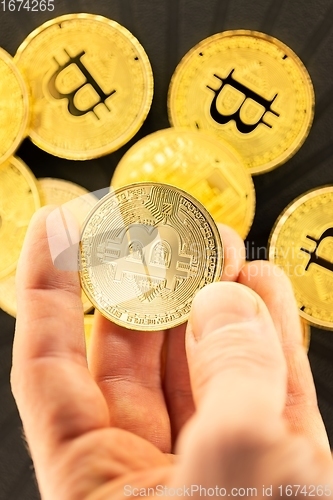 Image of Physical bitcoin held in hands closeup