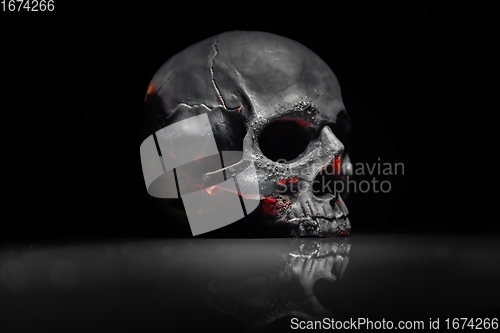 Image of Spooky dark black skull aginast dark background