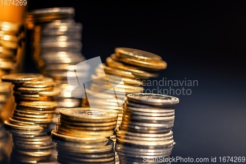 Image of Large pile of coins against dark background