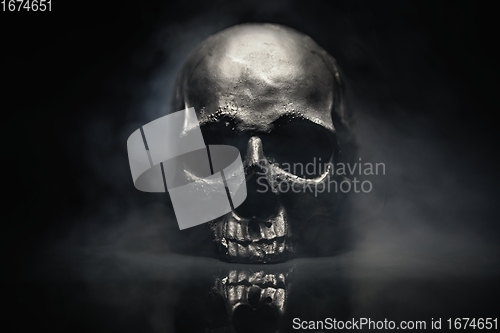 Image of Spooky dark black skull aginast dark background