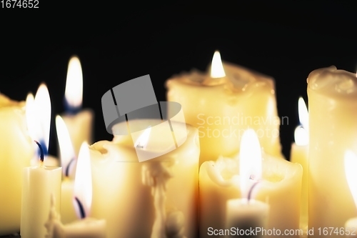 Image of Candles glowing against dark background