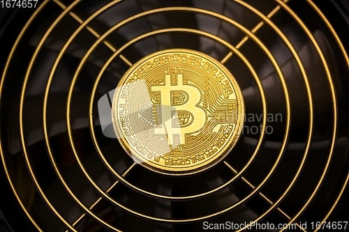 Image of Physical shiny bitcoin agains dark background