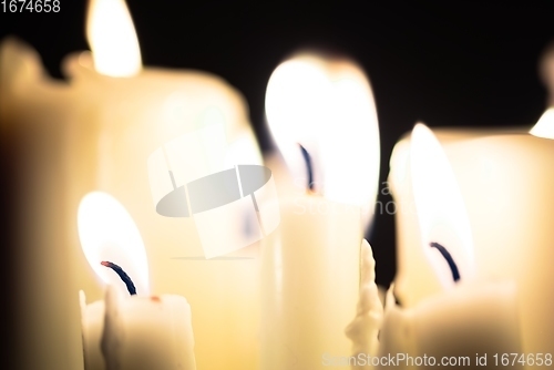 Image of Candles glowing against dark background