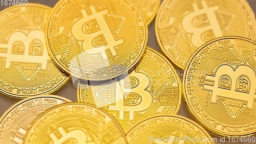 Image of Physical shiny bitcoin agains dark background