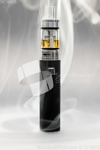 Image of Electronic cigarette against background full of smoke