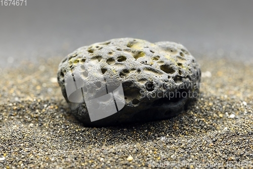 Image of Smoke whirling around small meteorite stone