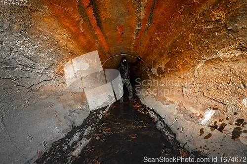 Image of Large sewage tunnel with filth flowing out