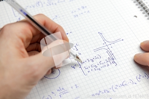 Image of Writing math exercise closeup photo