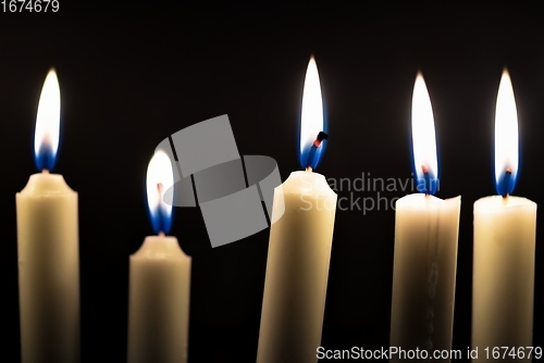 Image of Candles glowing against dark background