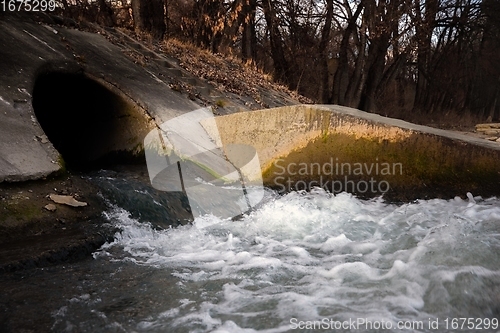 Image of Large sewage tunnel with filth flowing out