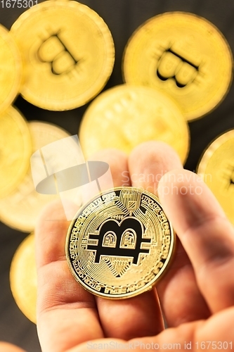 Image of Physical bitcoin held in hands closeup