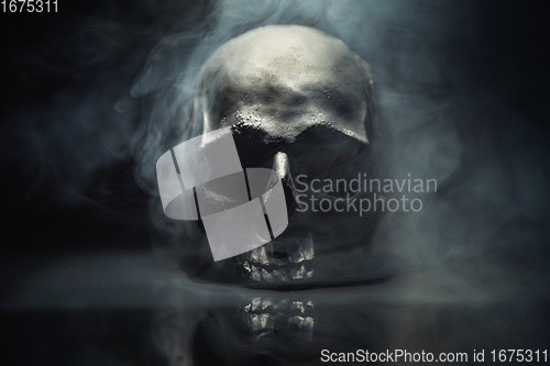 Image of Spooky dark black skull aginast dark background