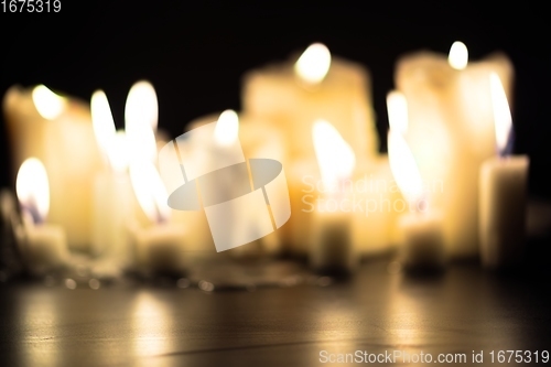 Image of Candles glowing against dark background