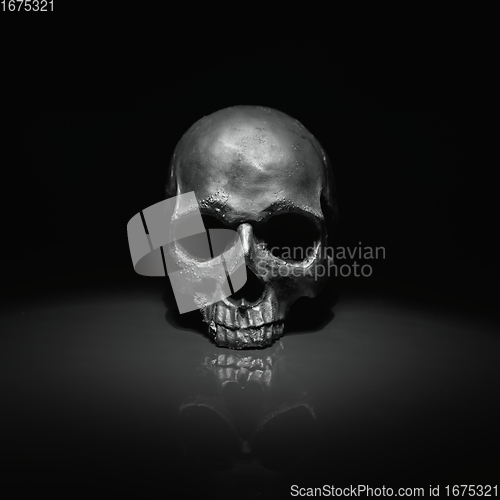Image of Spooky dark black skull aginast dark background