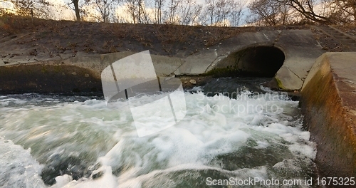 Image of Large sewage tunnel with filth flowing out