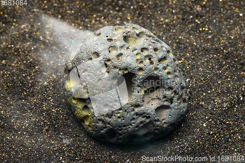 Image of Smoke whirling around small meteorite stone