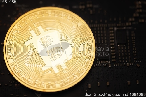 Image of Physical shiny bitcoin agains dark background