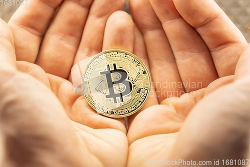 Image of Physical bitcoin held in hands closeup