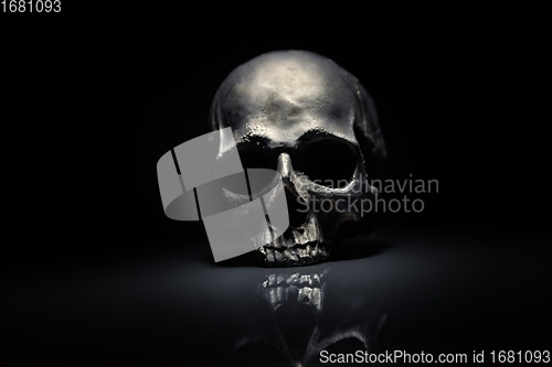 Image of Spooky dark black skull aginast dark background