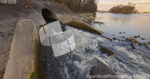 Image of Large sewage tunnel with filth flowing out