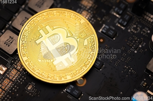 Image of Physical shiny bitcoin agains dark background