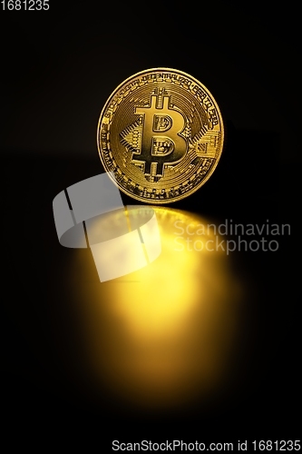 Image of Physical shiny bitcoin agains dark background