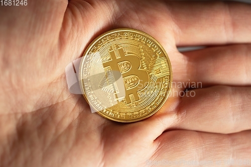 Image of Physical bitcoin held in hands closeup