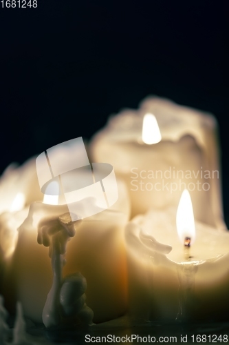 Image of Candles glowing against dark background