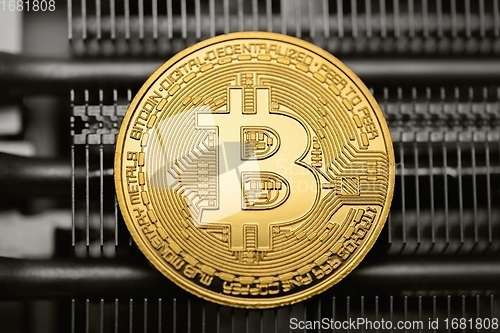 Image of Physical shiny bitcoin agains dark background