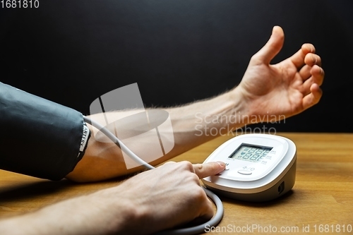 Image of Man measuring blood pressure closeup