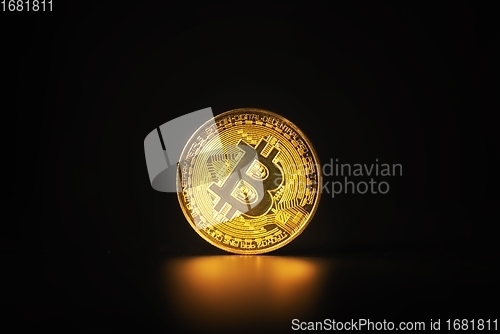 Image of Physical shiny bitcoin agains dark background