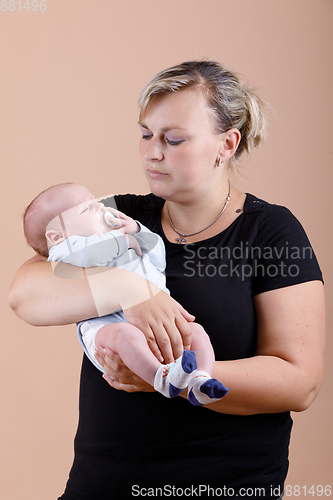 Image of Loving mother embracing her baby