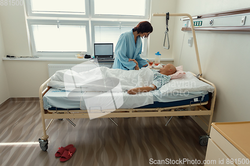 Image of woman patient with cancer in hospital with friend