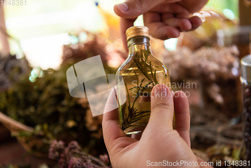 Image of potion bottle in hand of herbalist