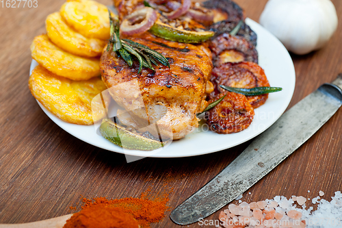 Image of roasted grilled BBQ chicken breast with herbs and spices 