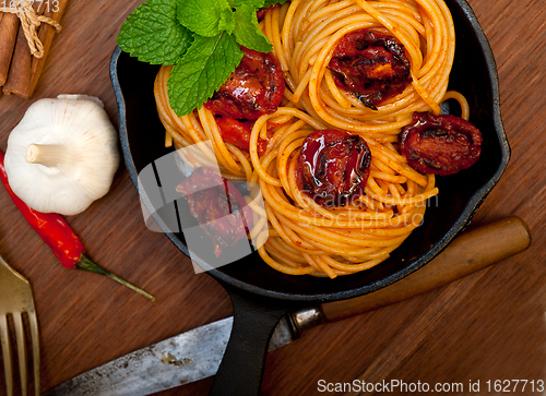Image of italian spaghetti pasta and tomato with mint leaves 