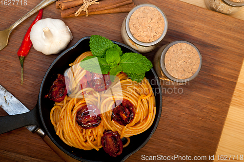 Image of italian spaghetti pasta and tomato with mint leaves 
