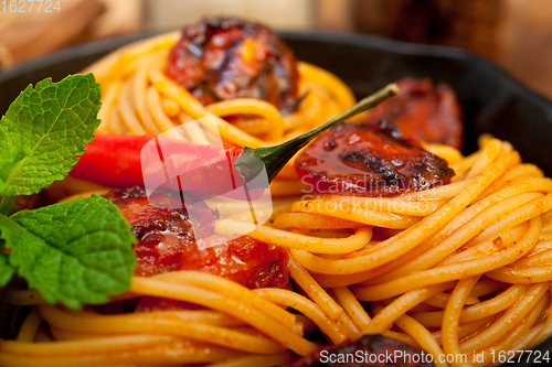 Image of italian spaghetti pasta and tomato with mint leaves 