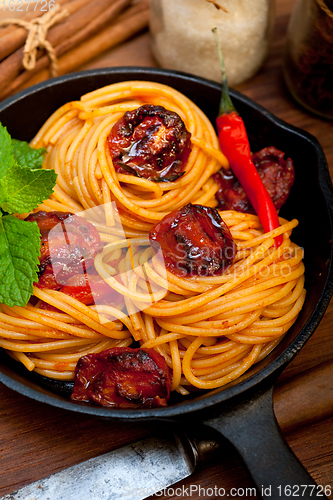 Image of italian spaghetti pasta and tomato with mint leaves 
