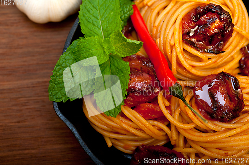 Image of italian spaghetti pasta and tomato with mint leaves 